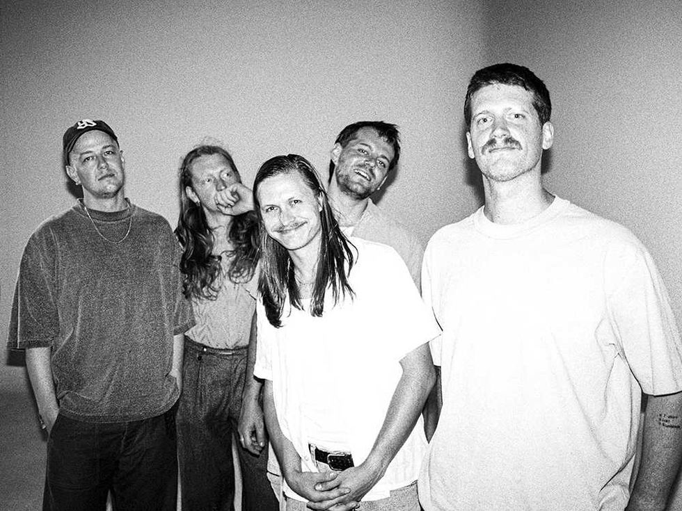Surprise Chef standing, some smiling, in a black and white photo.